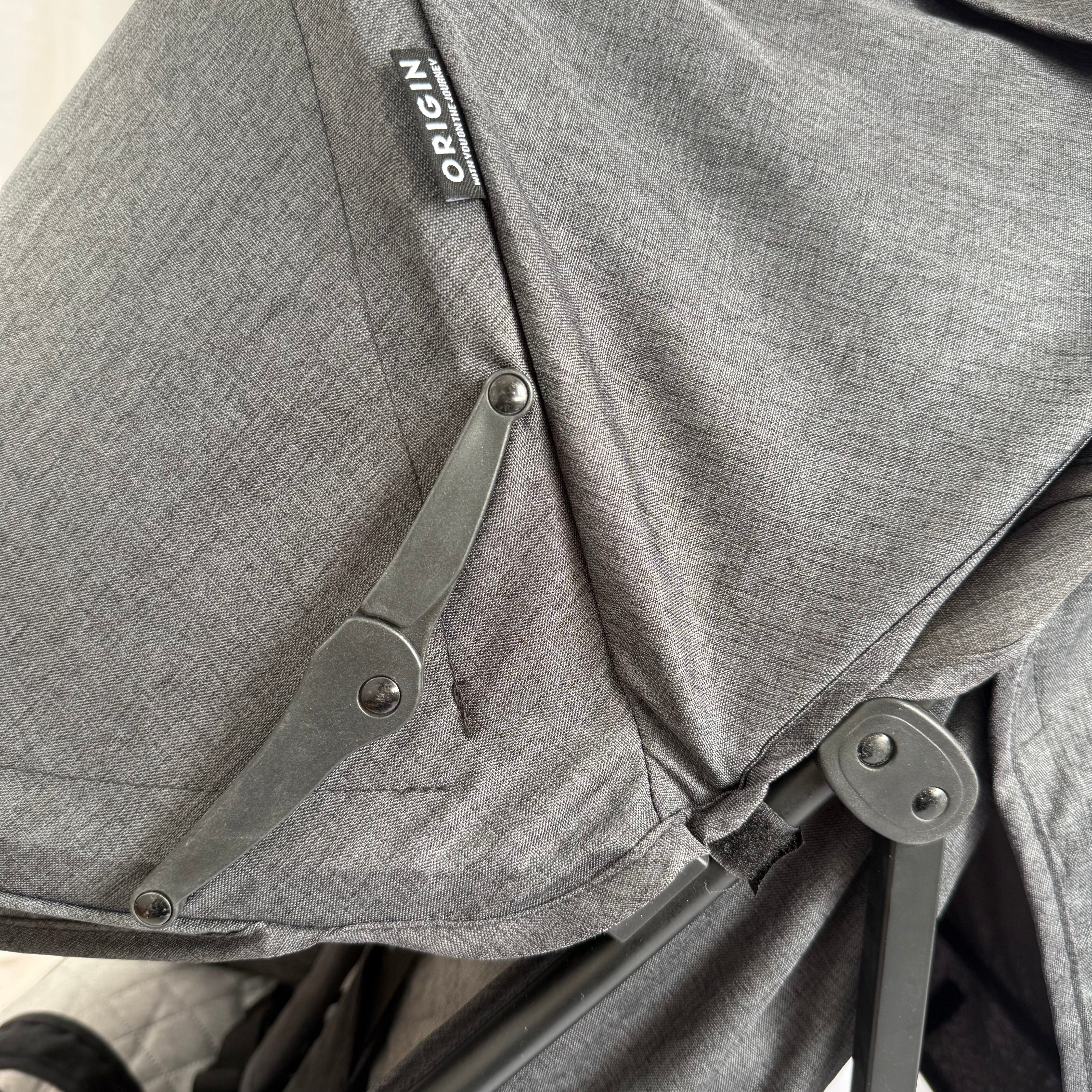 Close up of the ORIGIN Bellbird sunhood, showing the patterned fabric and mechanisms