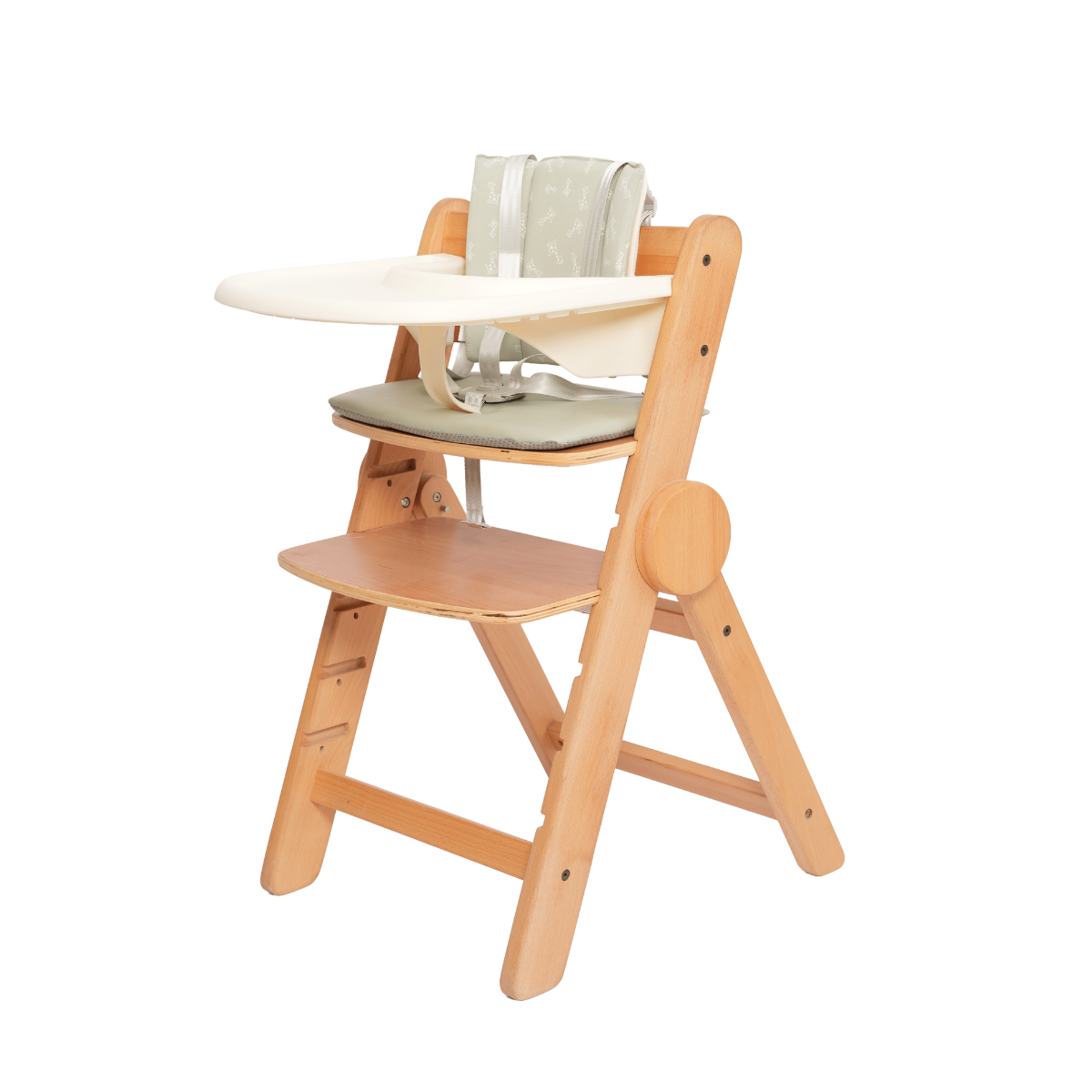 Wooden high chair with a white tray and green cushion on a white background
