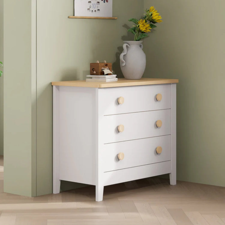 White Boori 3 draw dresser with wooden accents in a green bedroom with decor