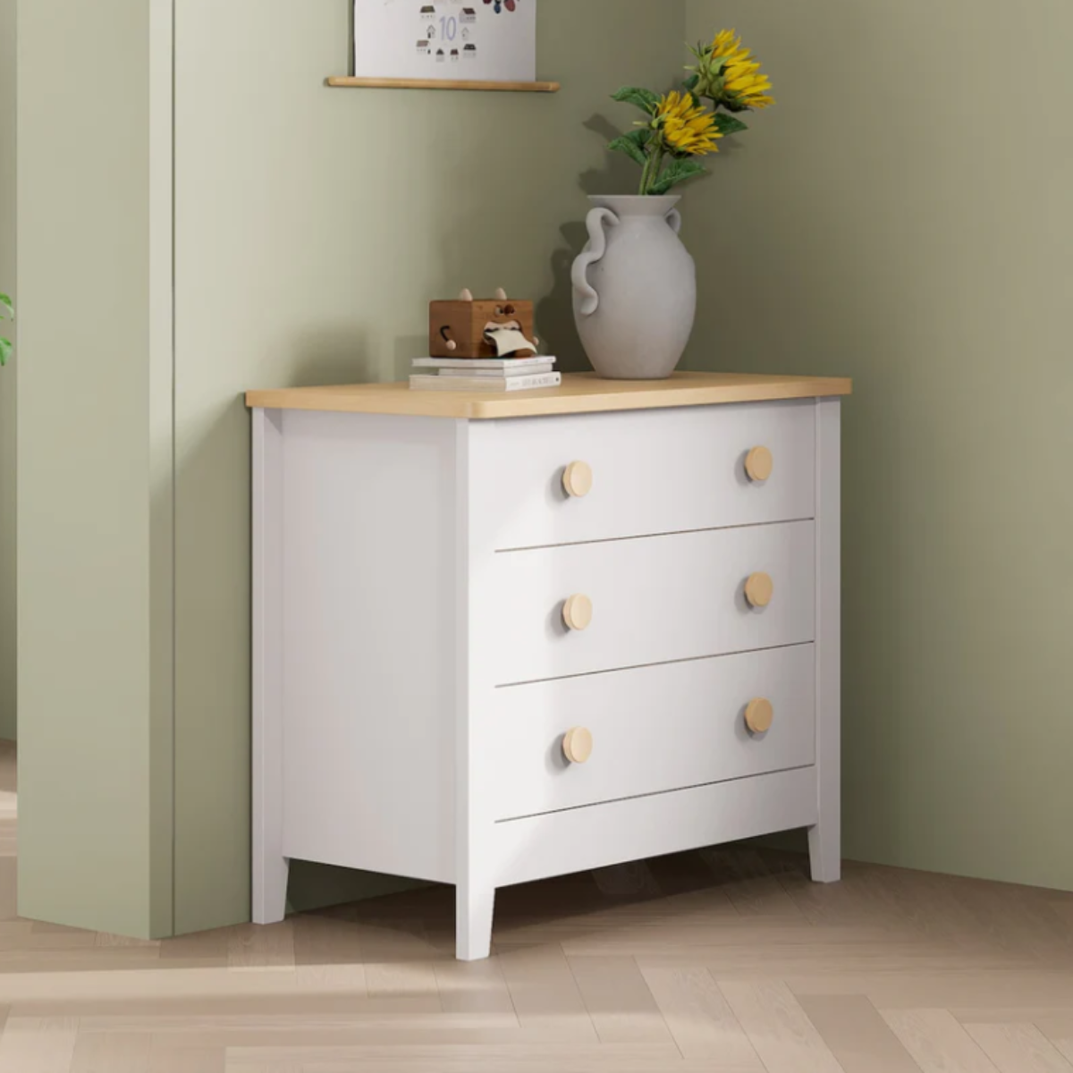 White Boori 3 draw dresser with wooden accents in a green bedroom with decor