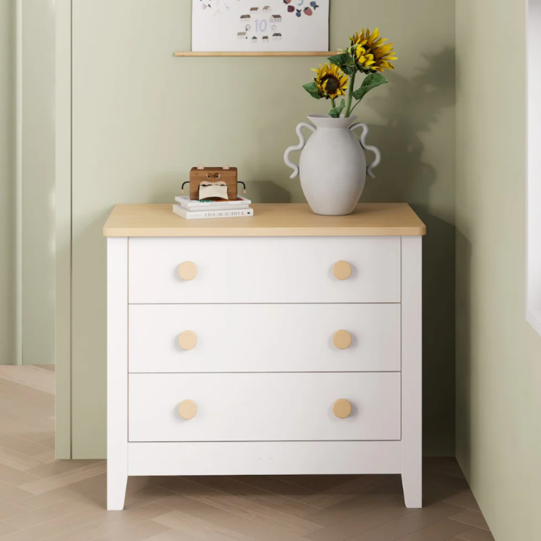White Boori 3 draw dresser with wooden accents in a green bedroom with decor