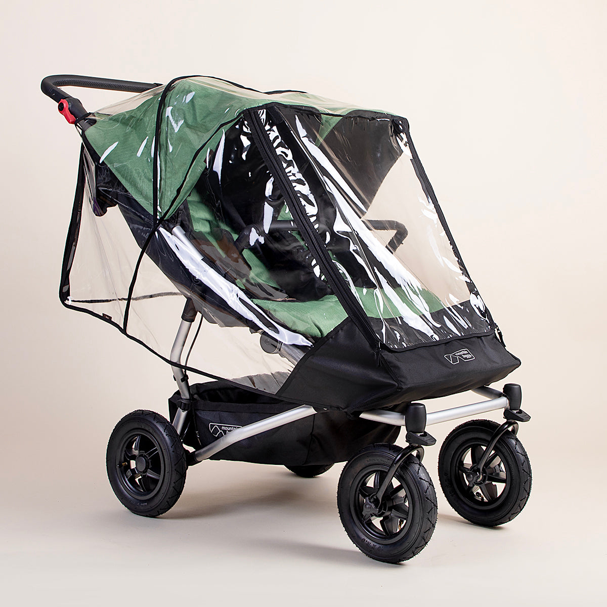 Full shot of the Mountain Buggy Duet Storm cover ontop of a Mountain Buggy Duet in matcha