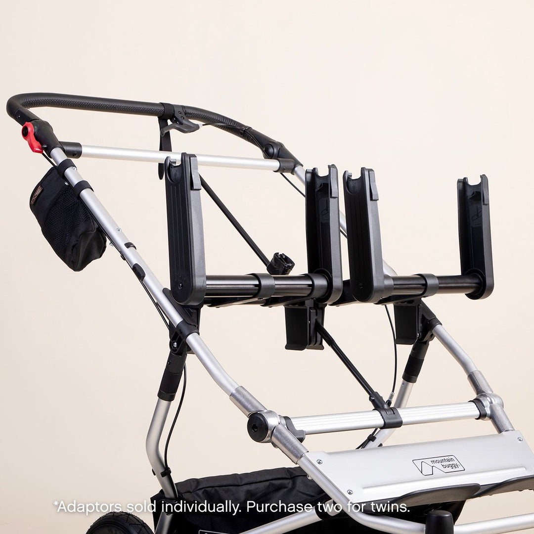 mid shot of a mountain buggy duet with dual car seat adaptors installed on a white background