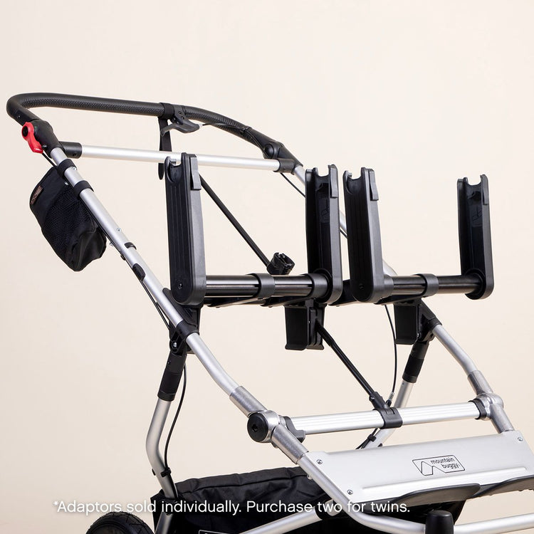 mid shot of a mountain buggy duet with dual car seat adaptors installed on a white background