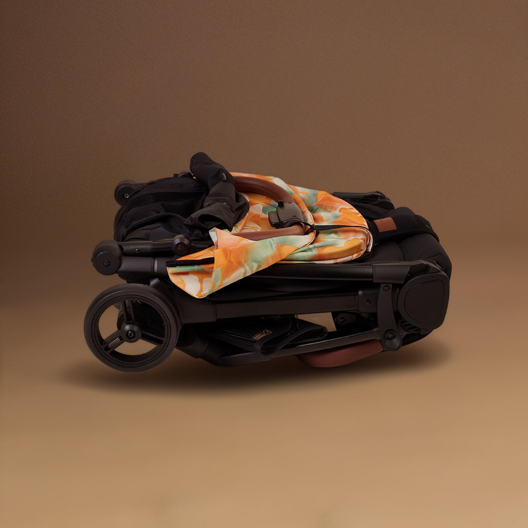 Closeup shot of the Mountain Buggy nano urban in Year of The horse folded up to show the pattern, shown against a brown background