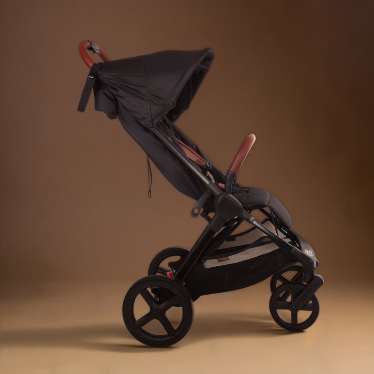 Full shot of the Mountain Buggy nano urban in black shown against a brown background