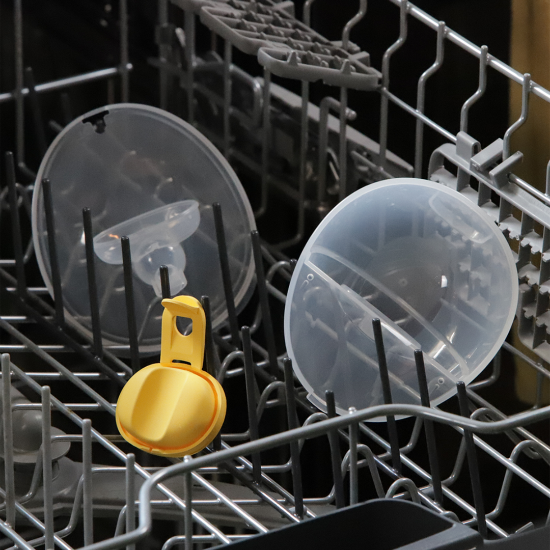 Gold measuring spoon among dishes in a dishwasher