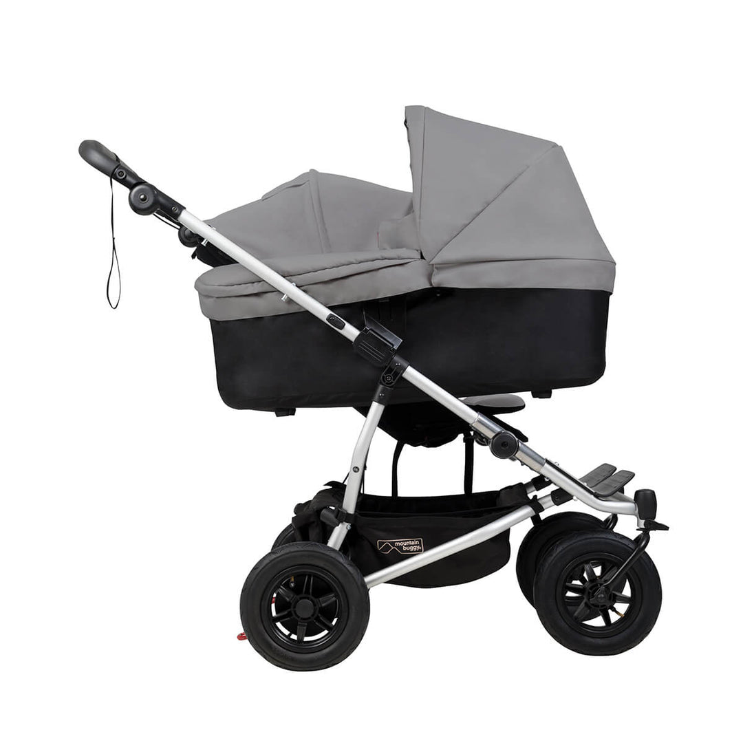 mountain buggy duet with one carrycot plus in lie flat mode side view shown in color silver_silver