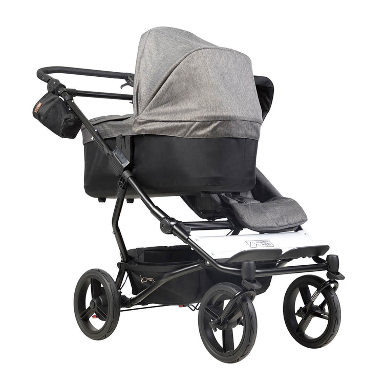 mountain buggy duet with one carrycot plus in lie flat mode three quarter view shown in color herringbone_herringbone