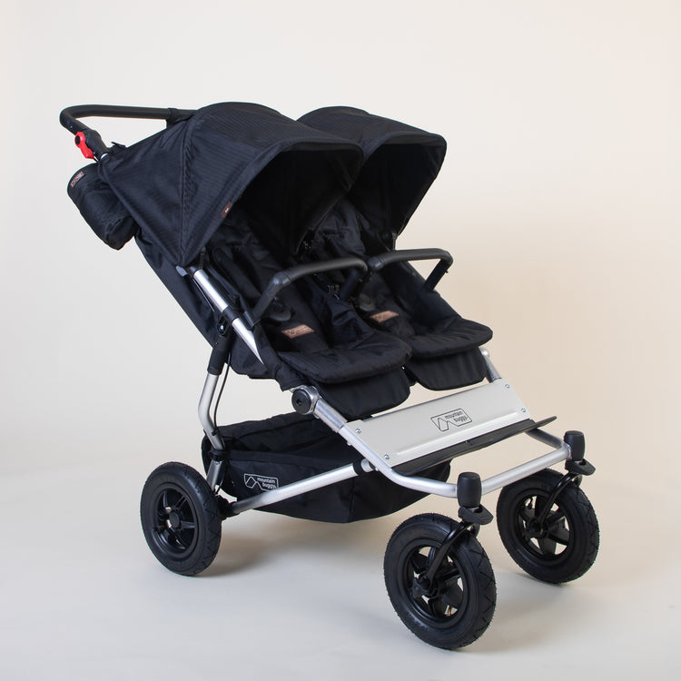 Full shot of Mountain Buggy duet in caviar black double front facing setup on a white background