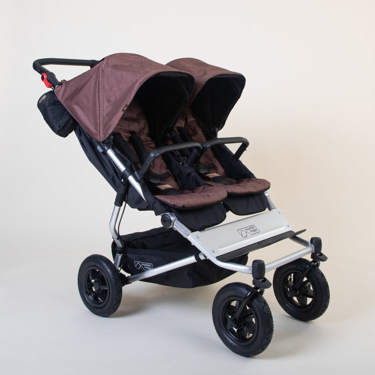 Full shot of Mountain Buggy duet in mustang brown double front facing setup on a white background