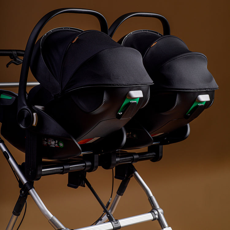 Close up shot of Mountain Buggy duet with dual travel system setup on brown background