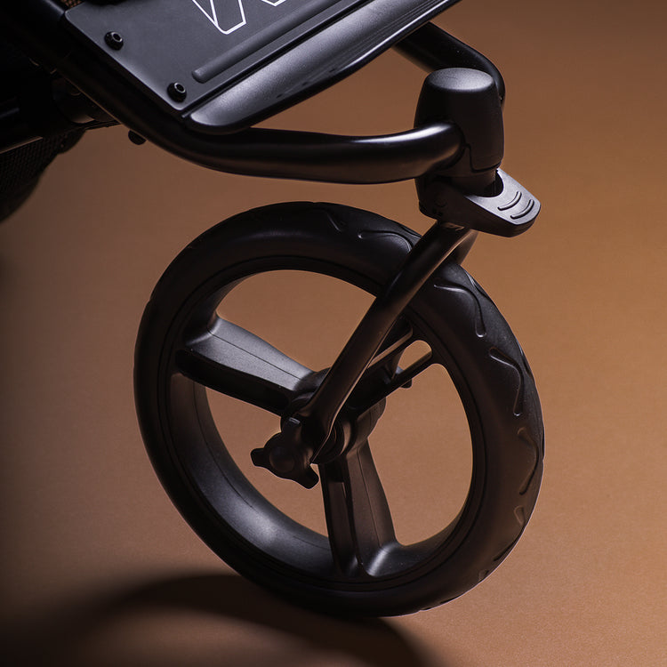 close up shot of the Mountain Buggy swift showcasing the kerb pop on a brown background