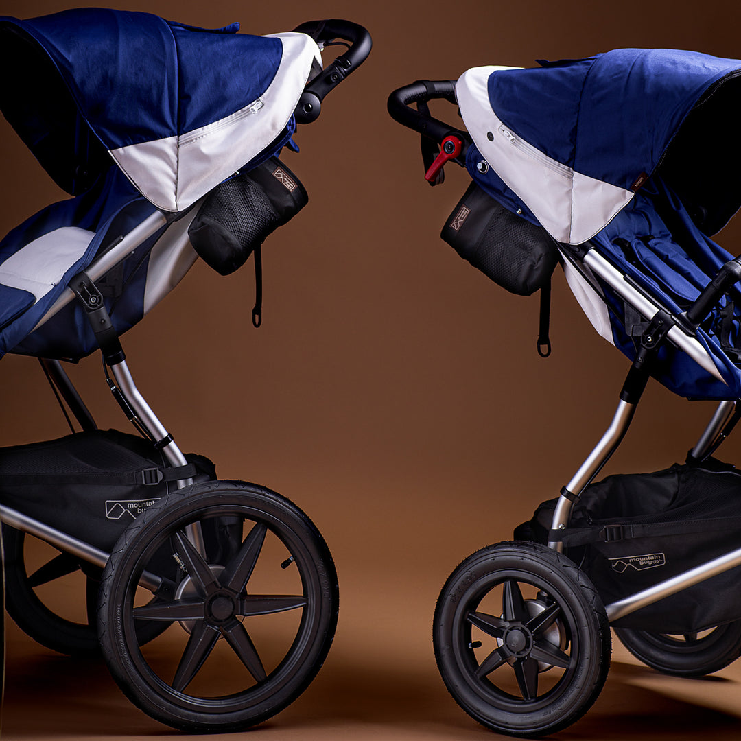 Full shot of two Mountain Buggy terrains in quartz back to back shown on a brown background