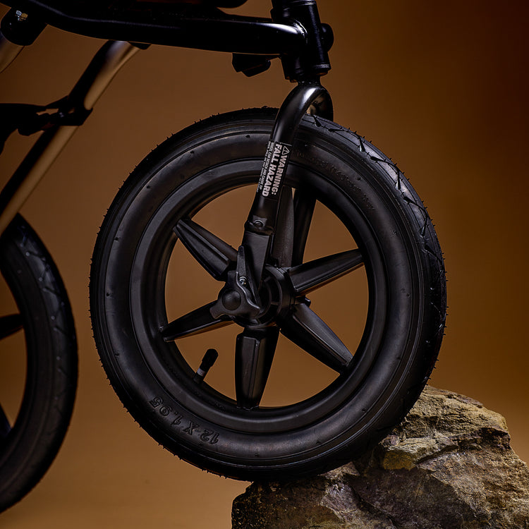 Close up of mountain buggy terrain wheel on a rock