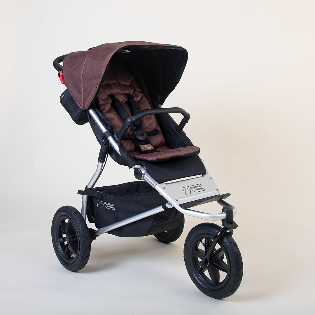 Full shot of the Mountain Buggy urban jungle in mustang brown shown on a white background