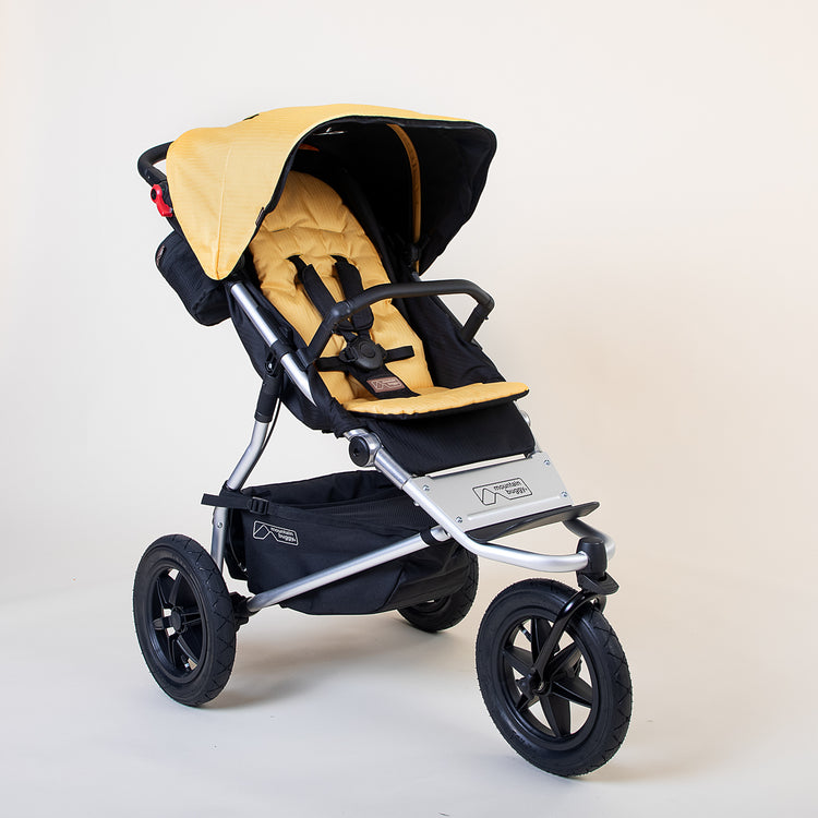 Full shot of the Mountain Buggy urban jungle in solare yellow shown on a white background