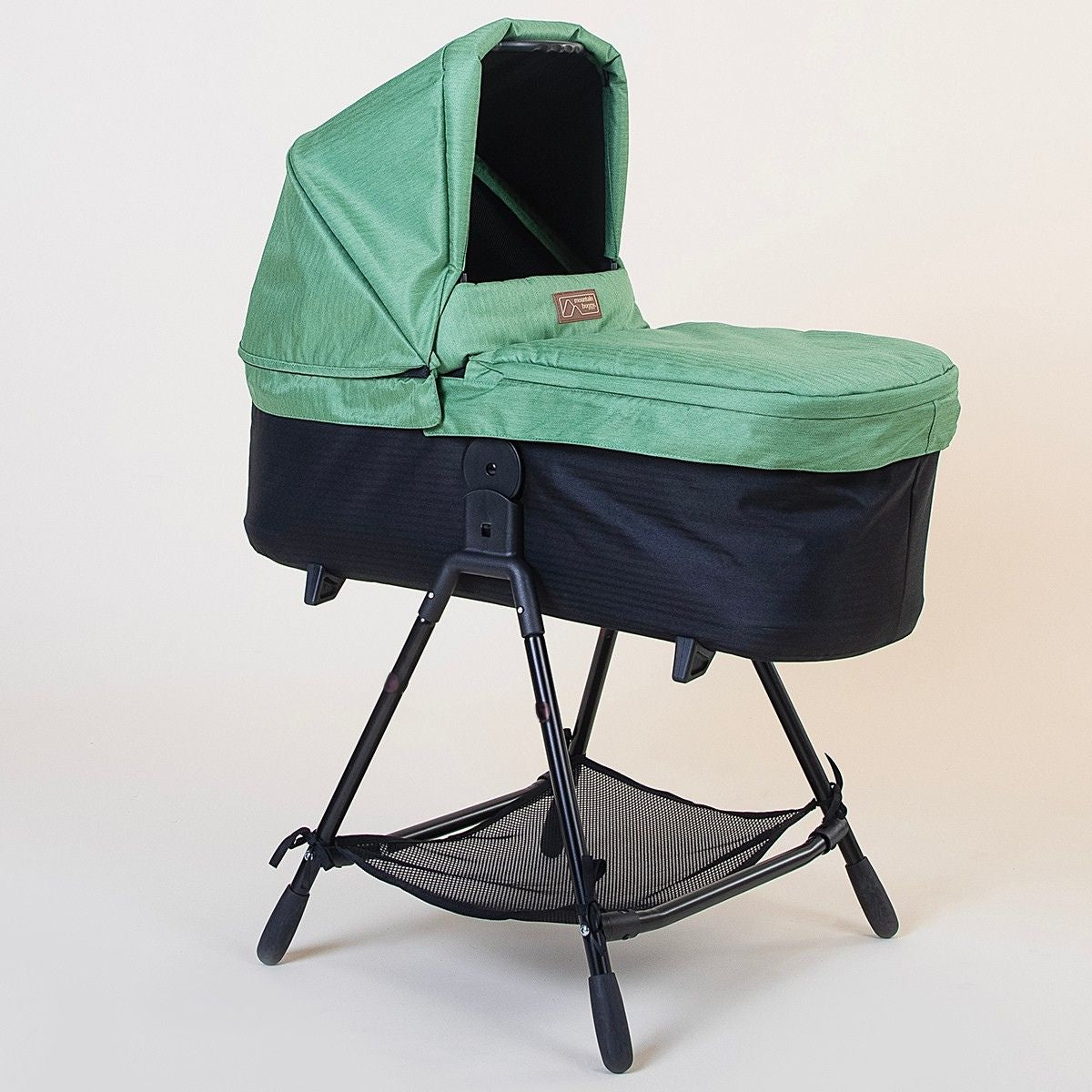 Full shot of Mountain Buggy carry cot plus for duet in matcha green on white background