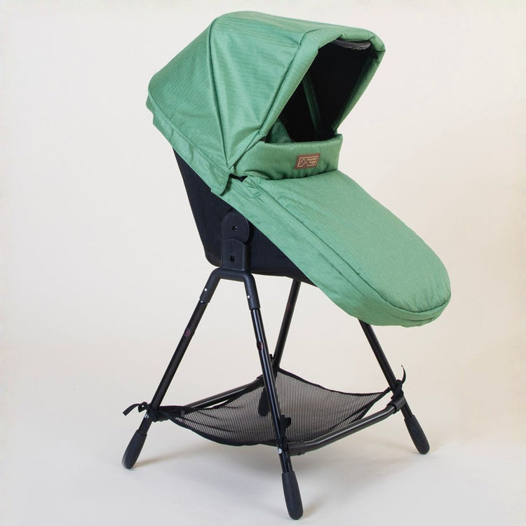 Full shot of Mountain Buggy carry cot plus for duet in matcha green showing toddler mode on a white background