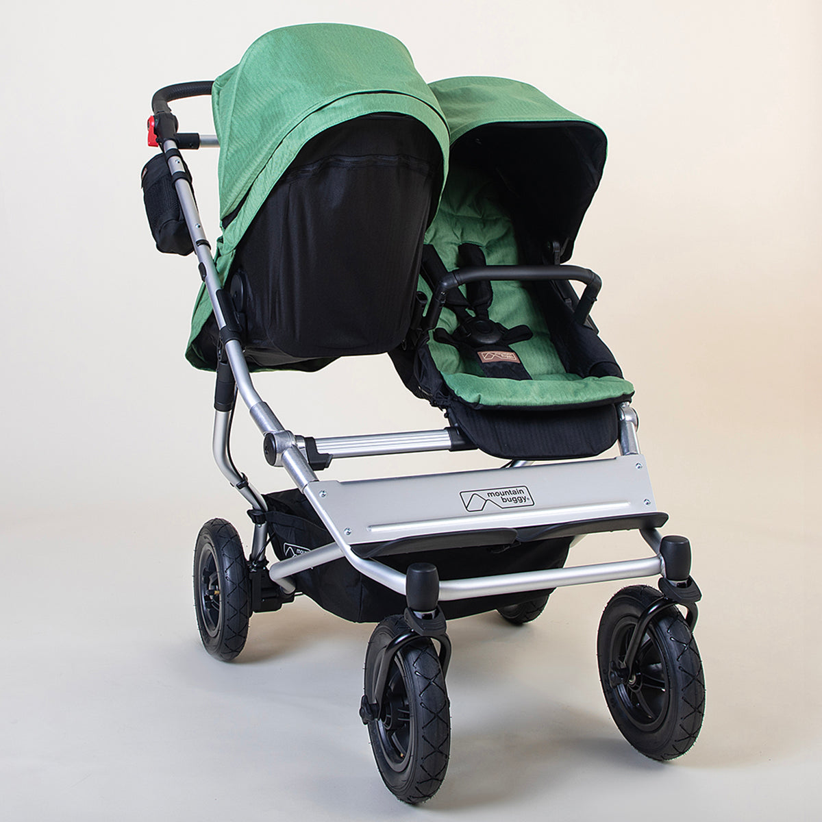 Full shot of Mountain Buggy duet with carry cot plus for duet in matcha green on white background