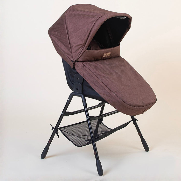 Full shot of the Mountain Buggy urban jungle carrycot plus in mustang brown on the stand accessory in toddler mode on a white background 