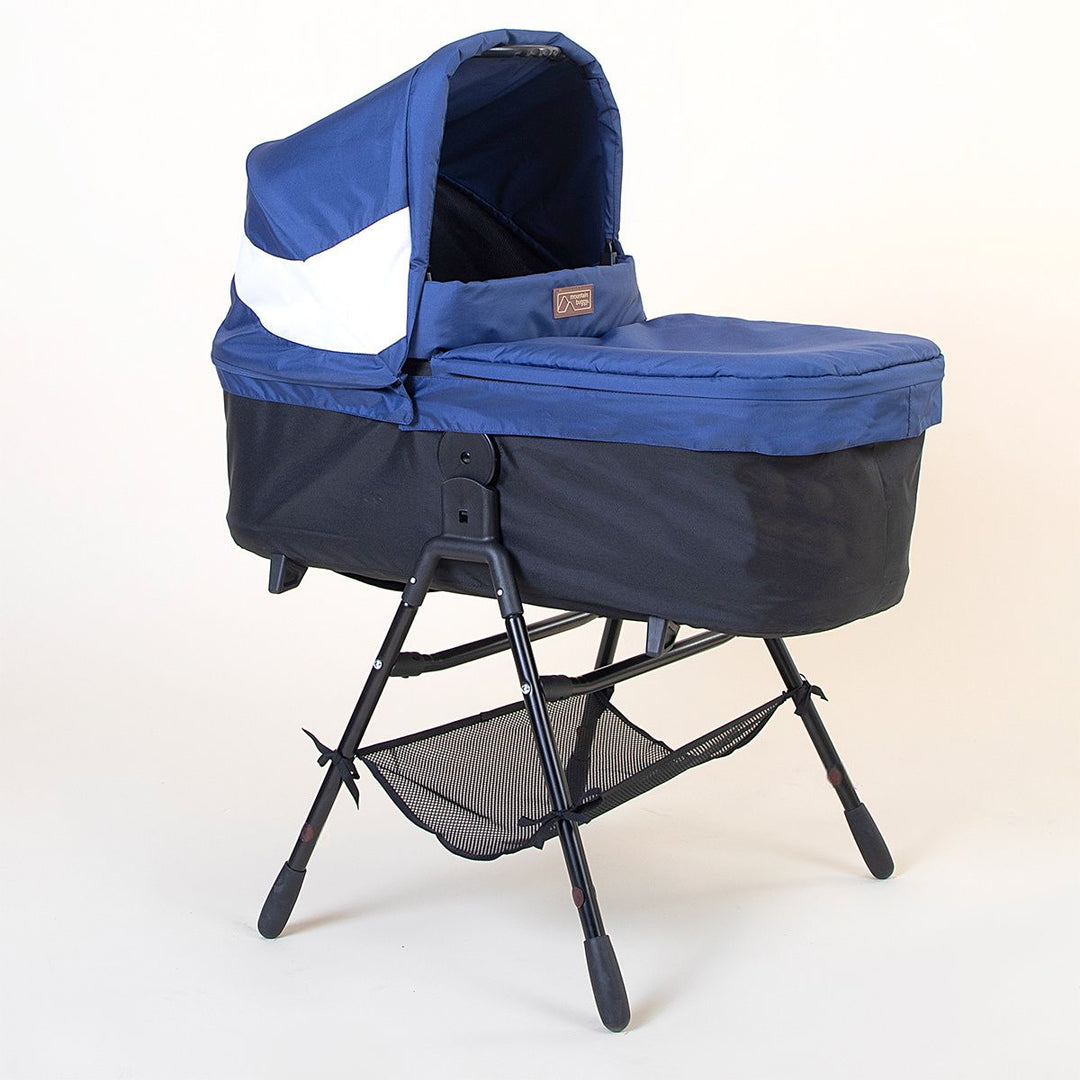Full shot of Mountain Buggy carry cot plus for terrain in quartz with stand on white background