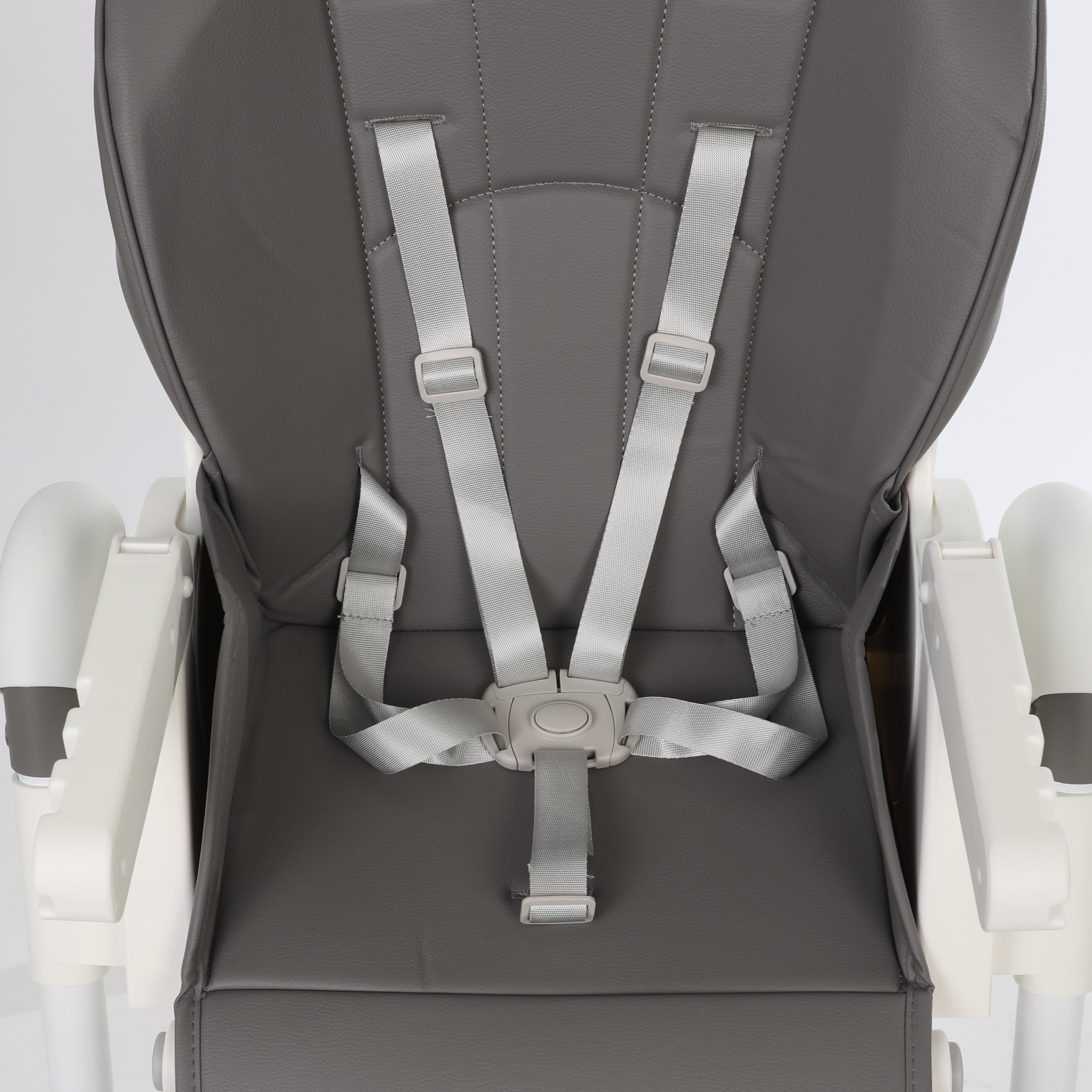 ORIGIN Marigold highchair closeup view showing safety harness on white background