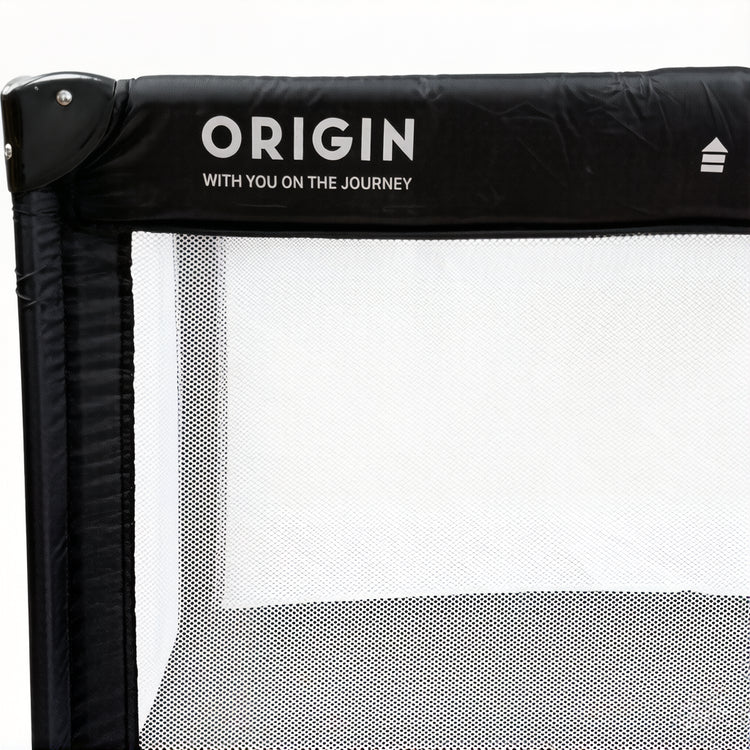 Close up of ORIGIN Weka portacot showing mesh side and logo