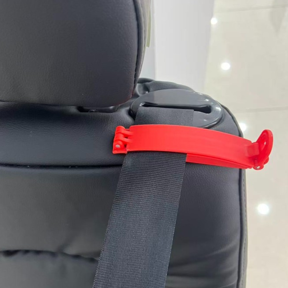 ORIGIN Belt Clamp attached to vehicle seat belt to keep sash from retracting during child seat installation.