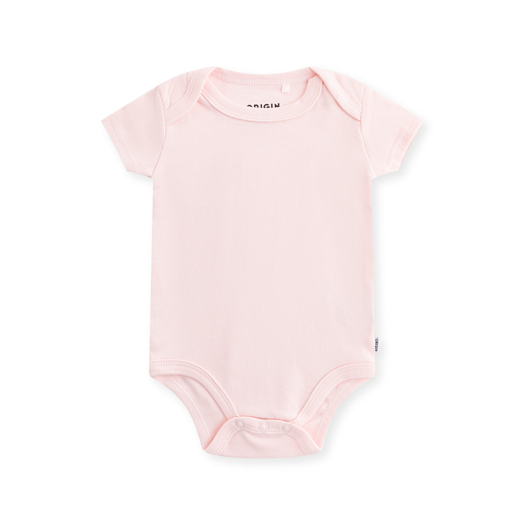 ORIGIN short sleeved baby bodysuit in solid pink with dome closure