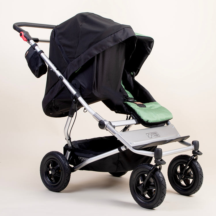 full shot of a mountain buggy duet carrycot plus blackout cover on a matcha carrycot plus in toddler mode next to a duet seat 