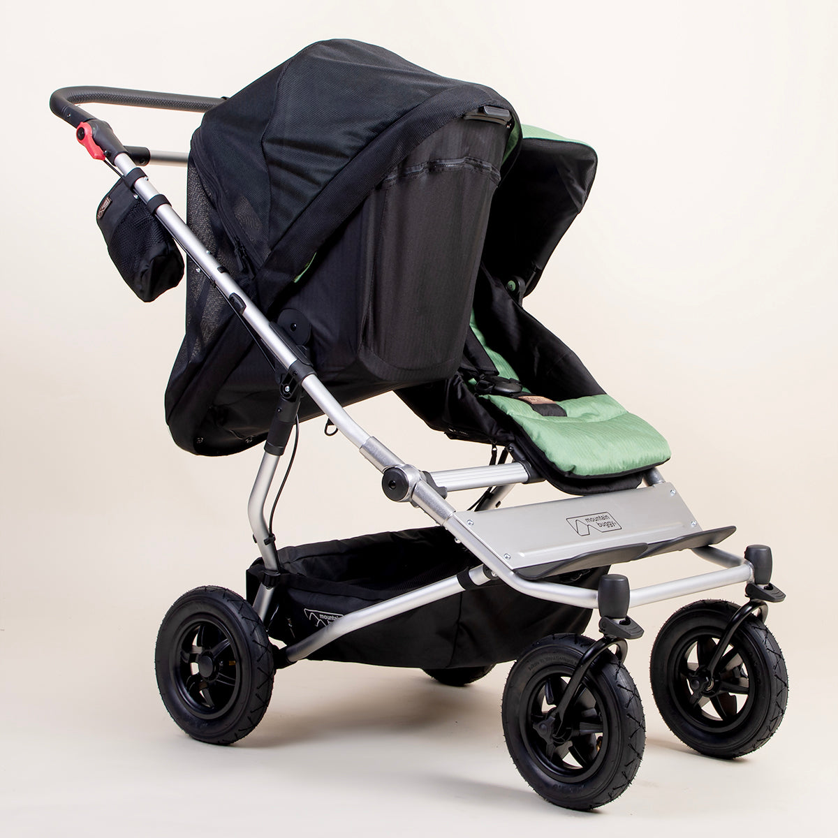 full shot of a mountain buggy duet carrycot plus mesh cover on a matcha carrycot plus in toddler mode next to a duet seat 