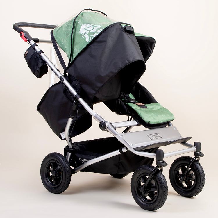 full shot of a mountain buggy duet carrycot plus storm cover on a matcha carrycot plus in toddler mode next to a duet seat 