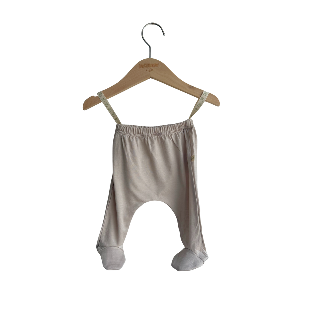 Baby harem pants on a wooden hanger against a white background