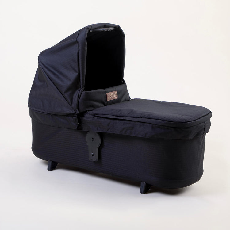 Full shot of Mountain Buggy carry cot plus for duet in caviar black on white background