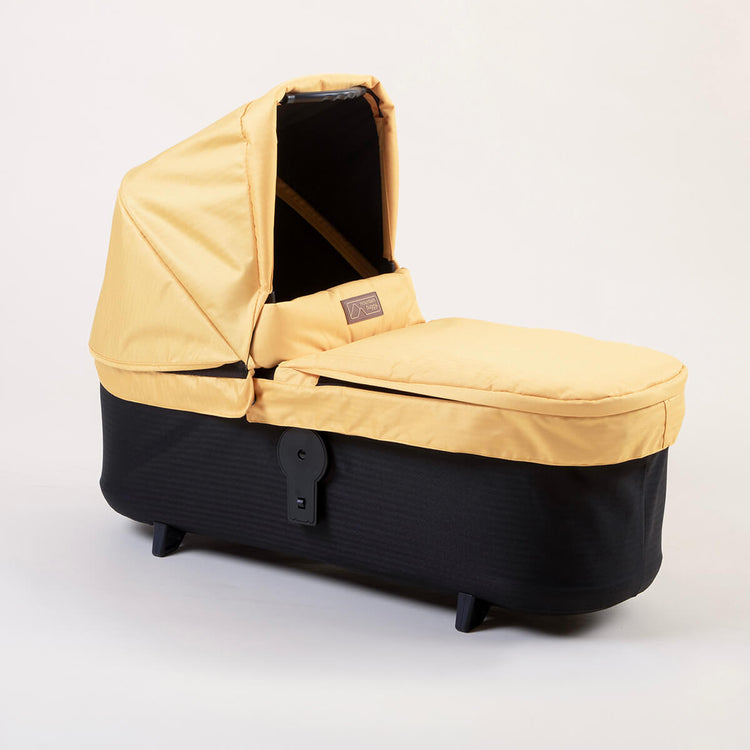 Full shot of Mountain Buggy carry cot plus for duet in solare yellow on white background