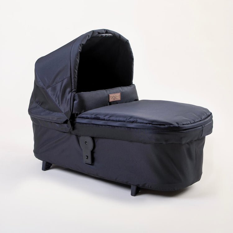 Full shot of Mountain Buggy carry cot plus for terrain in onyx on white background