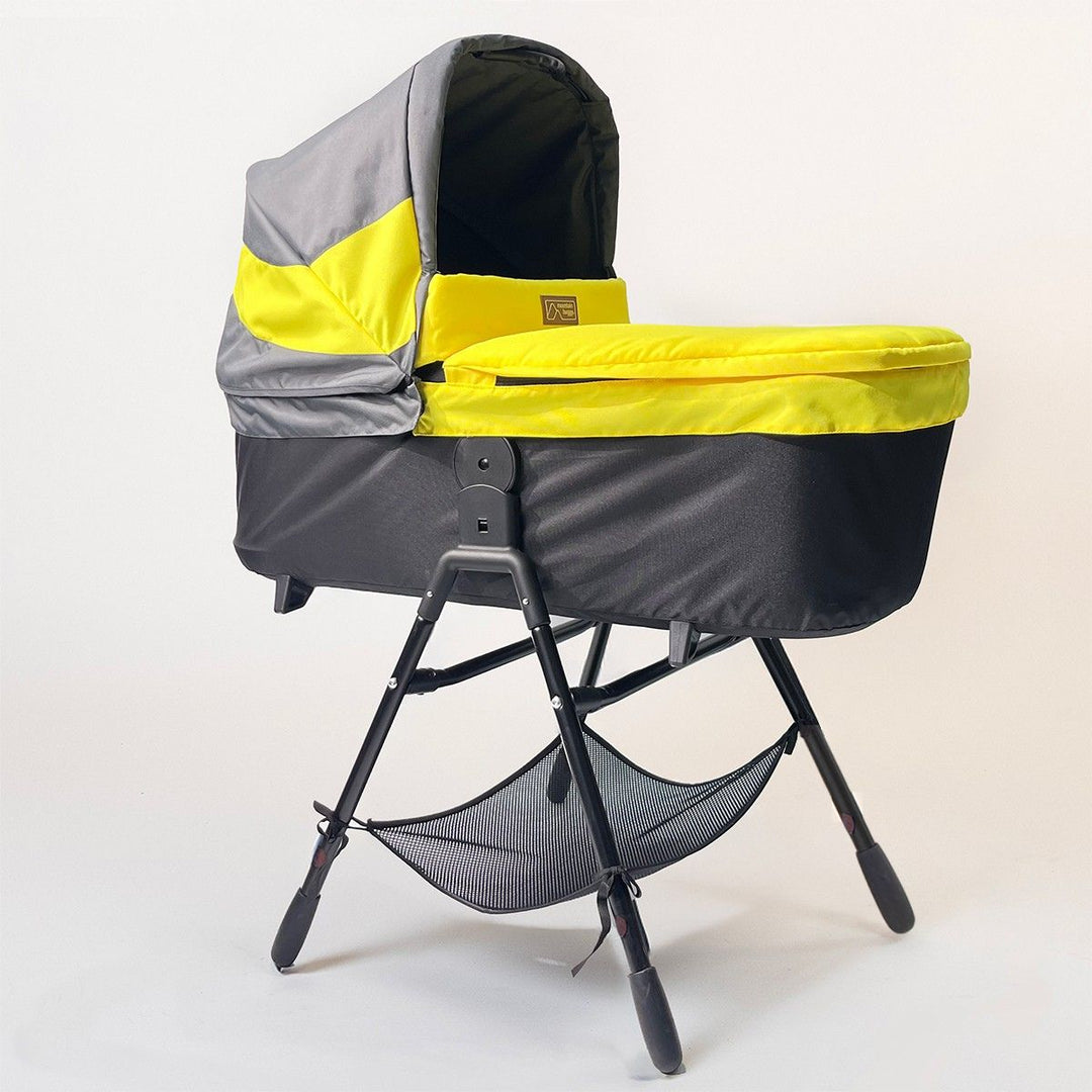 Full shot of Mountain Buggy carry cot plus for terrain in solare with stand on white background