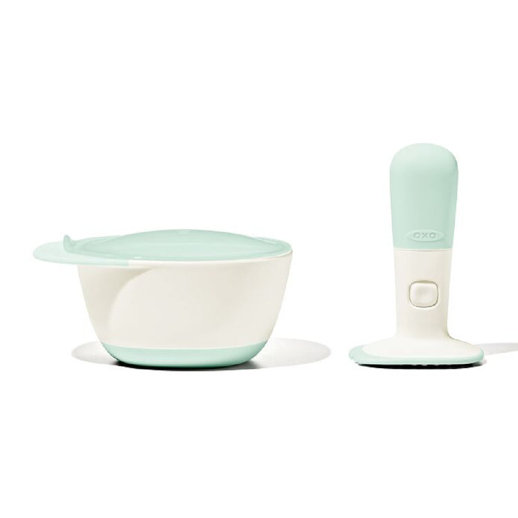 Mint green and white baby feeding set on a white background