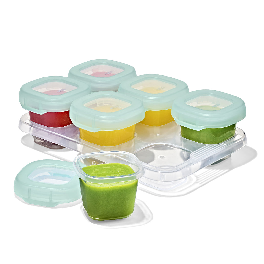 Set of baby food storage containers with colorful lids on a white background