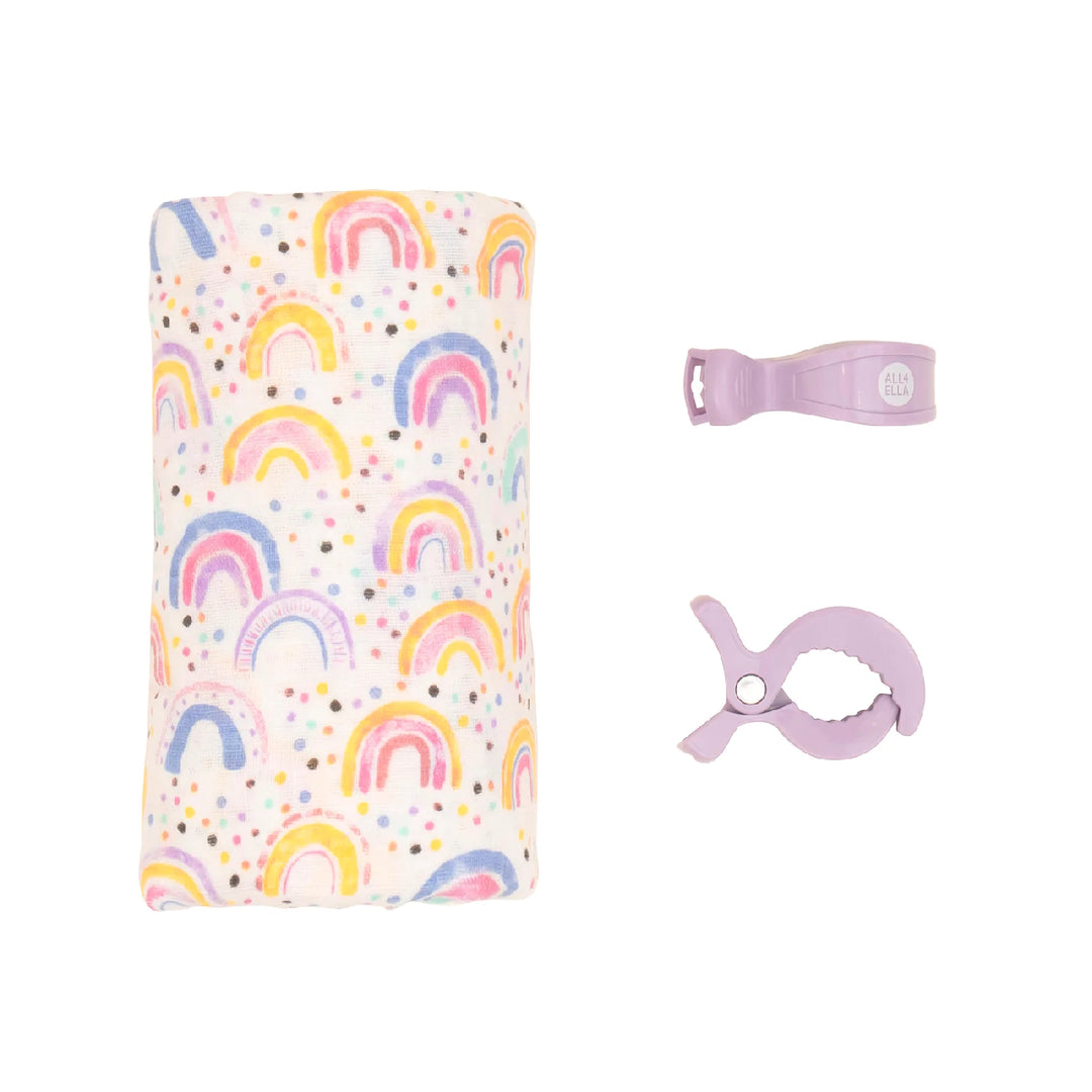 Baby bottle holder with rainbow pattern and accessories on a white background