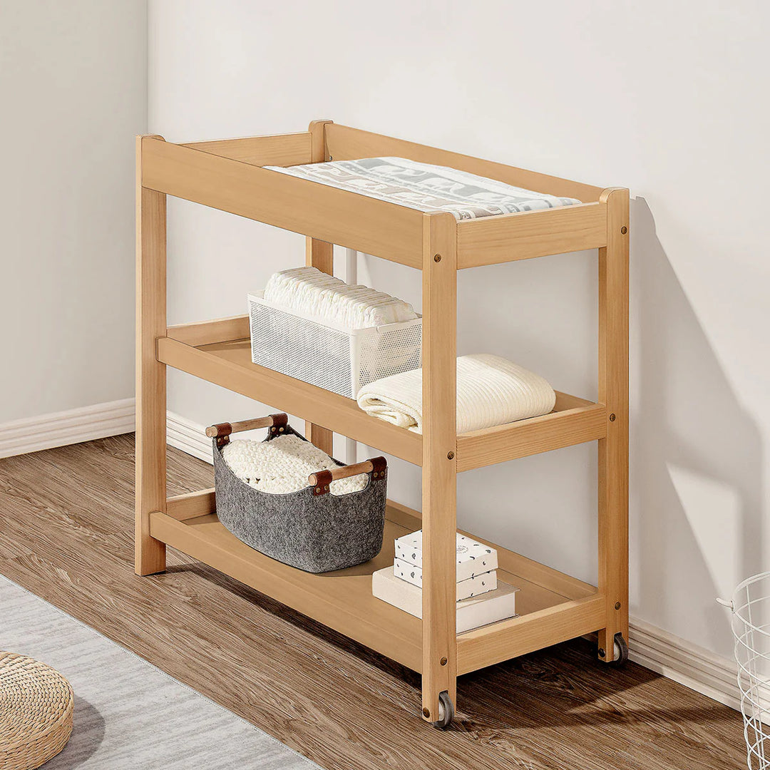 Wooden rolling cart with shelves against a white wall