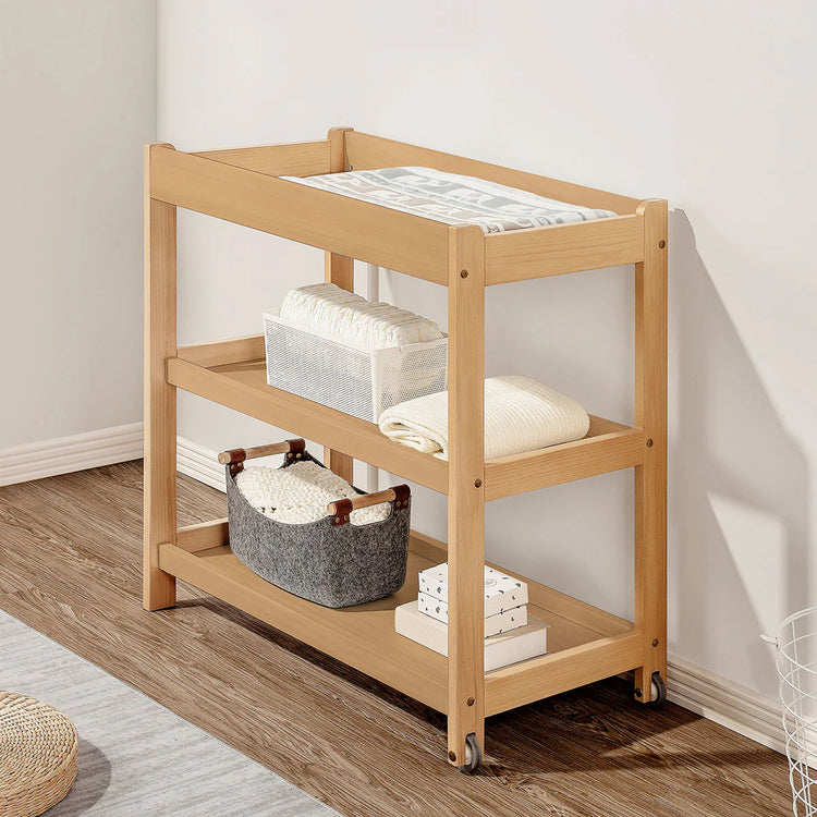Wooden rolling cart with shelves against a white wall