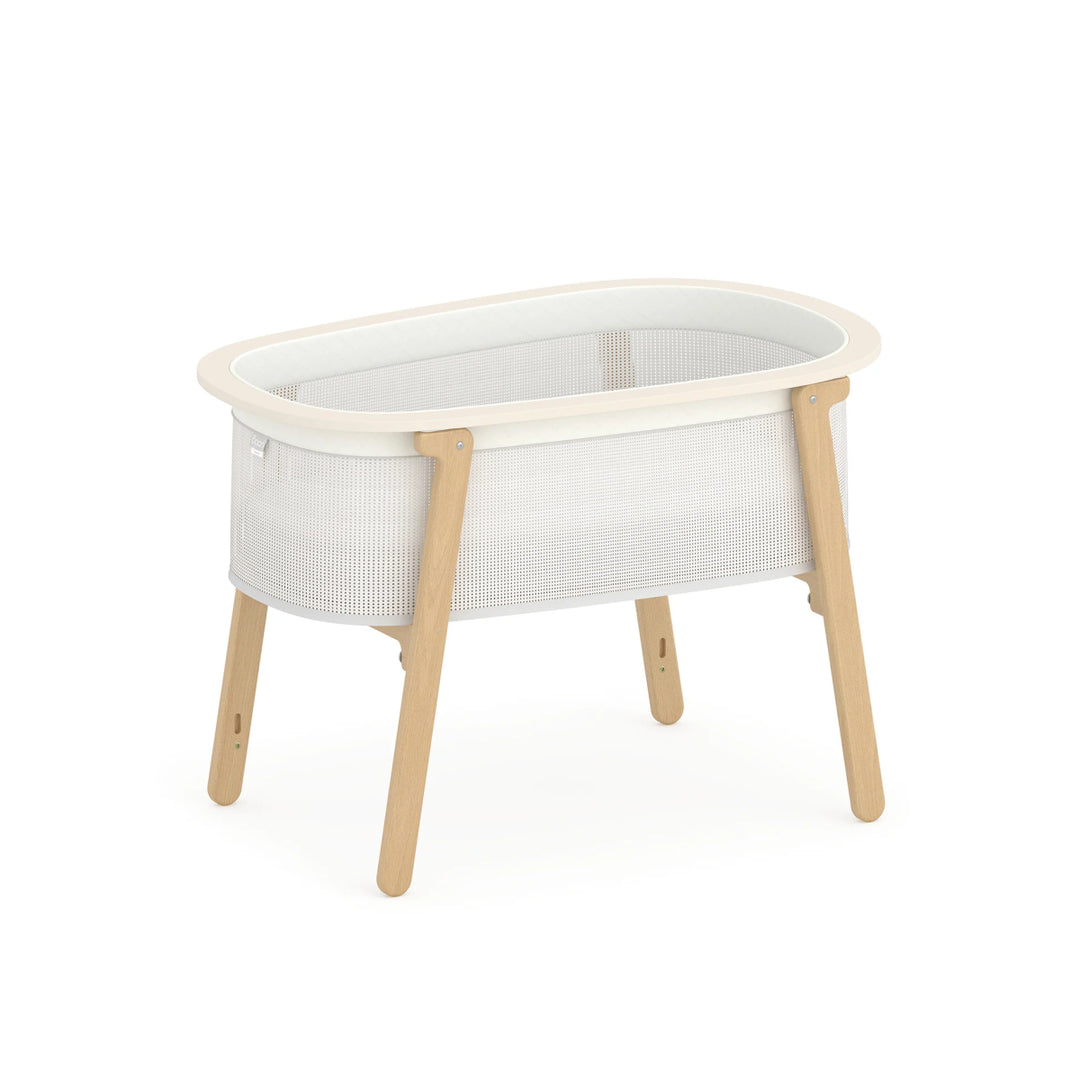 White crib with wooden legs on a white background