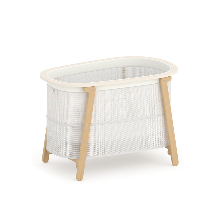 White crib with wooden legs on a white background