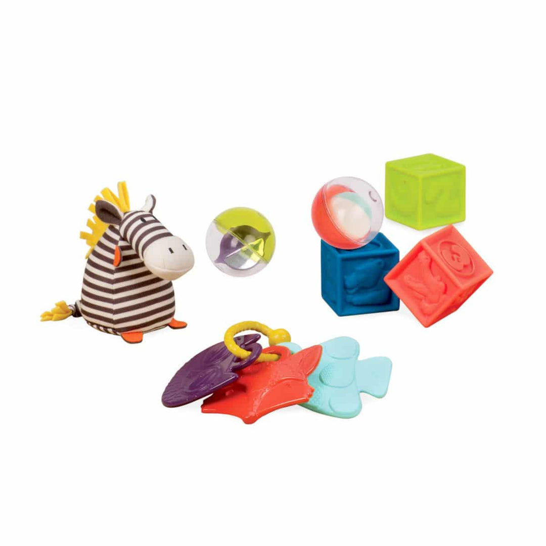 Colorful baby toys including a zebra, ball, and blocks on a white background