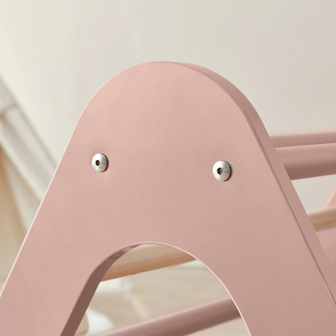 Close-up of a pink chair with metallic bolts on a blurred background
