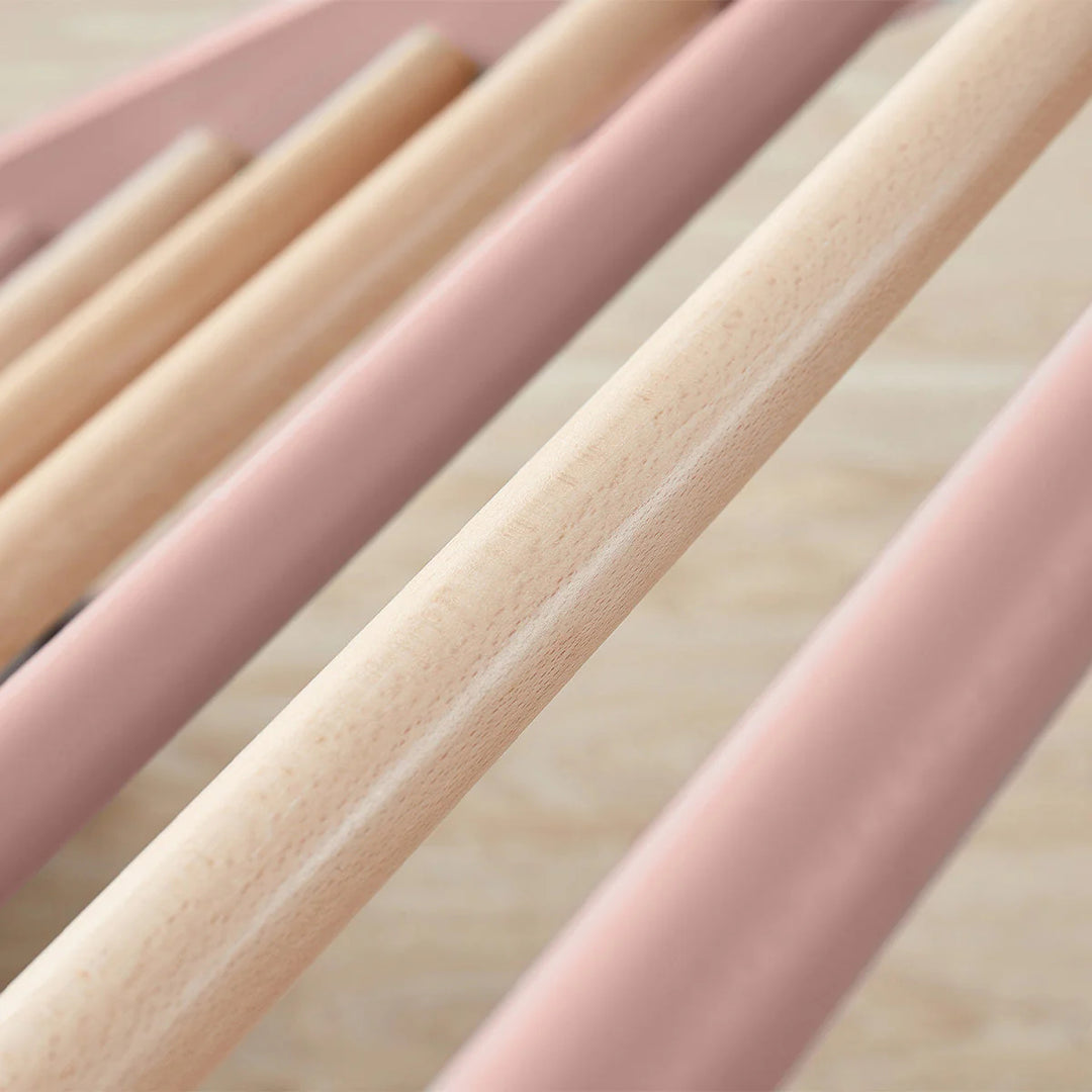 Close-up of pink and beige wooden sticks on a light background