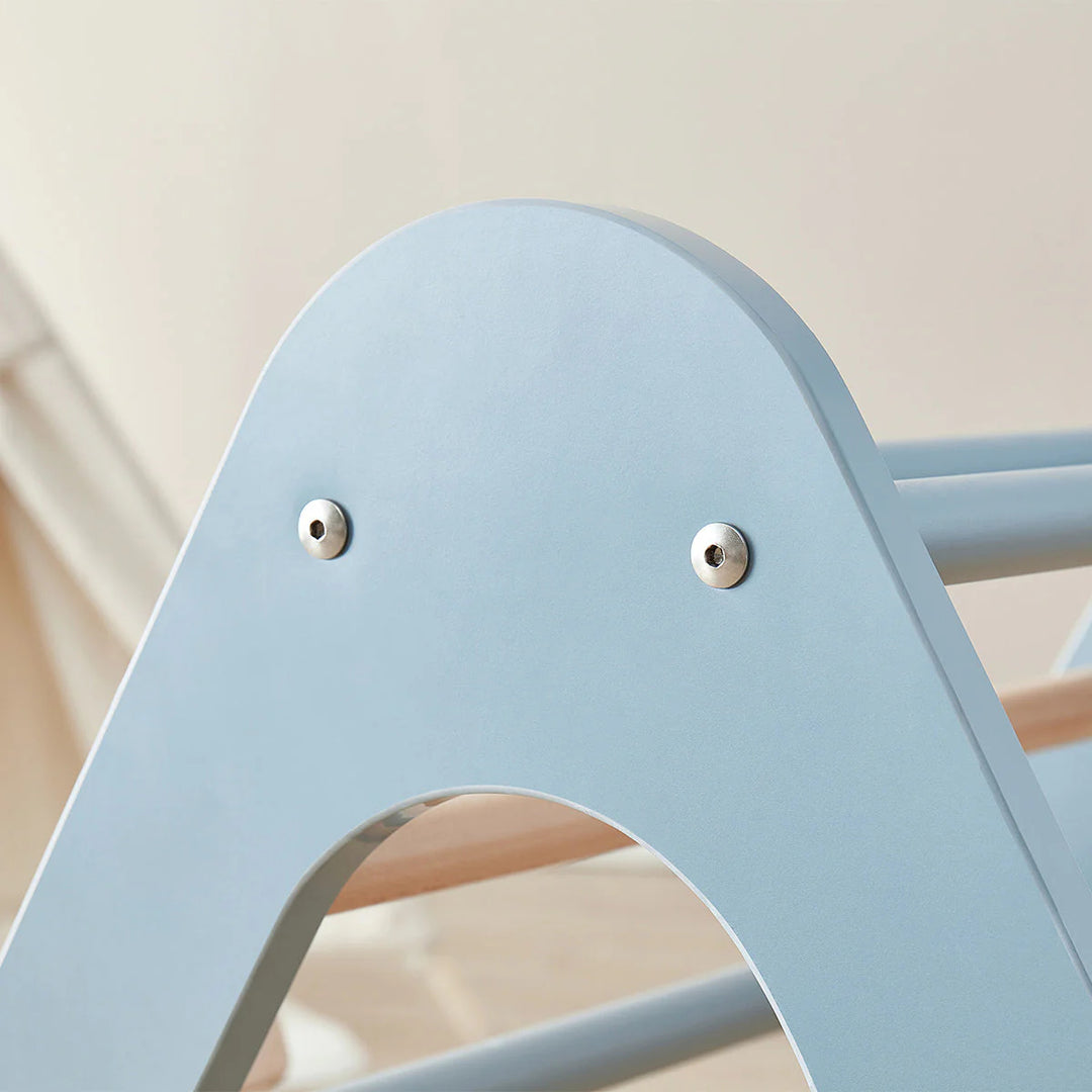 Light blue chair with metallic eyelets on a neutral background