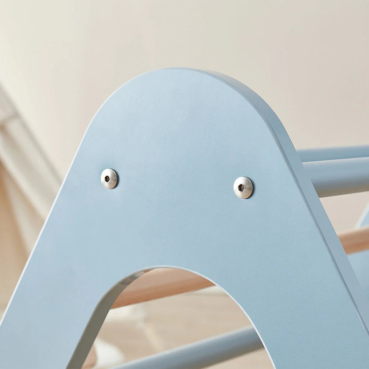 Light blue chair with metallic eyelets on a neutral background